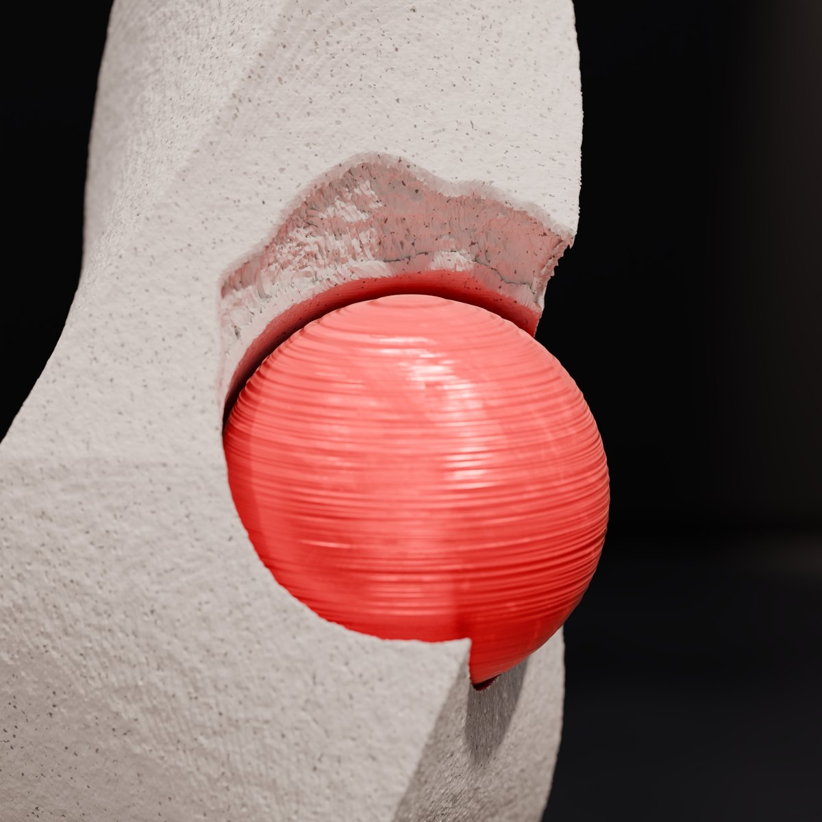 skulptur strength comes from within – detail des aufgemeisselten bruchs mit roter kugel